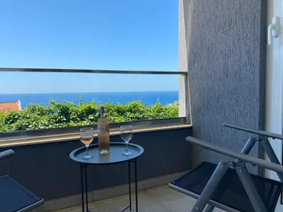 a table with a bottle of wine and two glasses at Ferienwohnung - Devas in Ulcinj