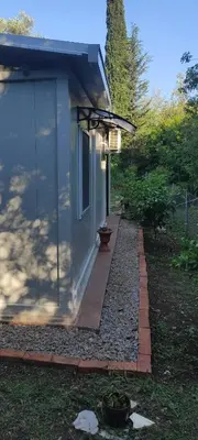 a house with a walkway next to a building at Apartman sa sopstvenim dvoristem , pored mora in Bigovo