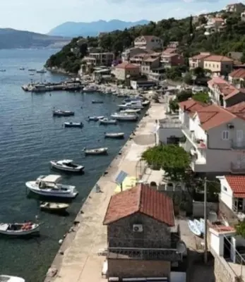 a group of boats are docked in a harbor at Apartman sa sopstvenim dvoristem , pored mora in Bigovo