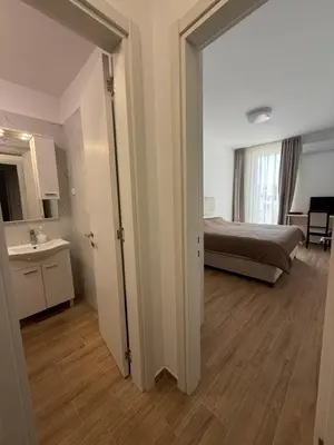 a bedroom with a bed and a bathroom with a mirror at Apart Hotel Spa Resort Becici, Budva Апартаменты с двумя мастер-спальнями in Becici