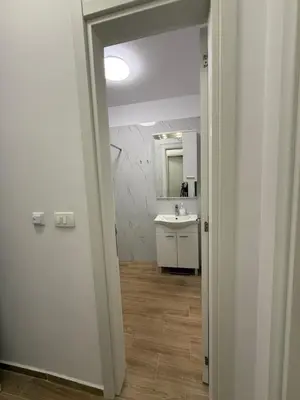a white bathroom with a sink and a mirror at Apart Hotel Spa Resort Becici, Budva Апартаменты с двумя мастер-спальнями in Becici