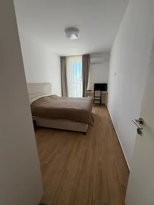 a bedroom with a bed and a wooden floor at Apart Hotel Spa Resort Becici, Budva Апартаменты с двумя мастер-спальнями in Becici