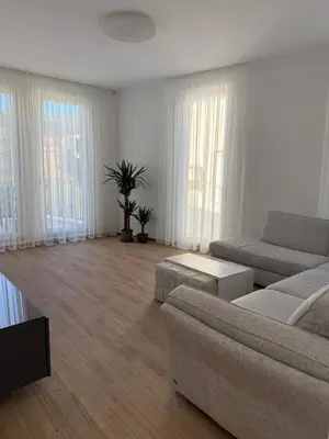 a living room with a couch and tables and windows at Apart Hotel Spa Resort Becici, Budva Апартаменты с двумя мастер-спальнями in Becici