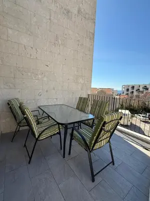 a table and chairs sitting on a patio at Apart Hotel Spa Resort Becici, Budva Апартаменты с двумя мастер-спальнями in Becici