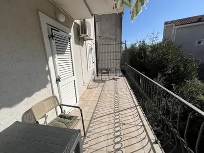 a balcony with a bench next to a door at Perfect studio-apartment in Petrovac in Petrovac na Moru
