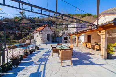 an outdoor patio with a table and chairs at Village Villa Dobrski Dvori in Cetinje