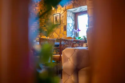 a room with a table and chairs and a window at Village Villa Dobrski Dvori in Cetinje