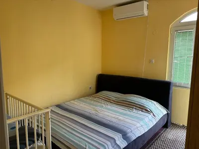 a small bedroom with a bed and a window at Galicia Hill in Boreti