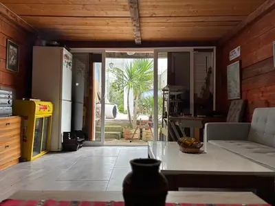 a kitchen with a refrigerator and a table in a room at Galicia Hill in Boreti