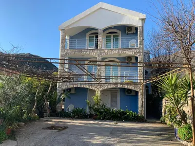 a blue house with a balcony on top of it at Galicia Hill in Boreti