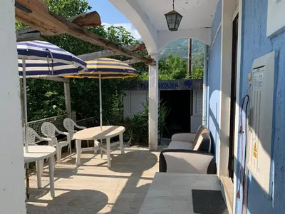 an outdoor patio with tables and chairs and umbrellas at Galicia Hill in Boreti