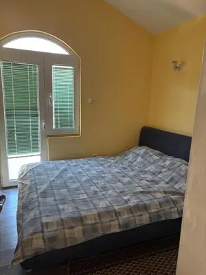 a bedroom with a bed and a large window at Galicia Hills in Becici