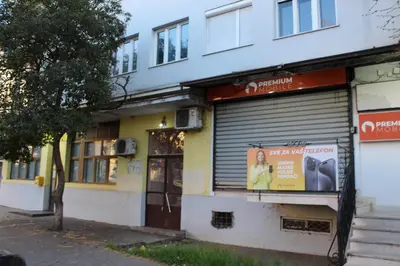 a store with a sign in the front of a building at Moraca River Residence in Podgorica