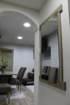 a mirror in a dining room with a table and chairs at Moraca River Residence in Podgorica