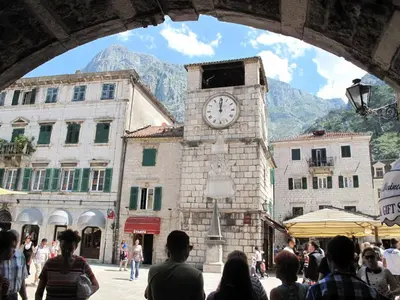 a clock tower in the middle of a crowd of people at Apartments Ana in Kotor