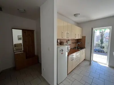 a kitchen with a white refrigerator and a sink at Perfect spot Petrovac in Petrovac na Moru