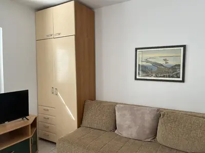 a living room with a couch and a television at Perfect spot Petrovac in Petrovac na Moru