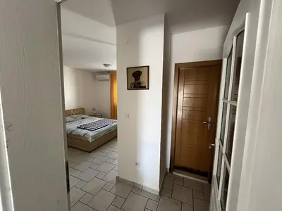 a room with a bed and a hallway with a door at Perfect spot Petrovac in Petrovac na Moru