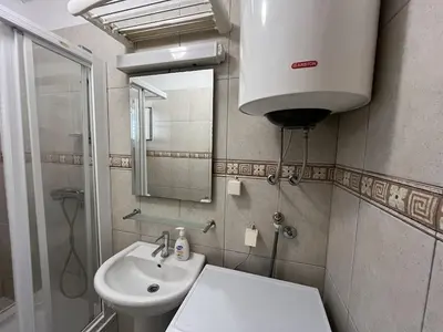 a bathroom with a sink and a toilet and a mirror at Perfect spot Petrovac in Petrovac na Moru
