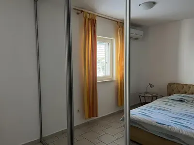 a bedroom with a bed and a window at Perfect spot Petrovac in Petrovac na Moru
