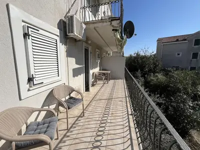a balcony of a house with two chairs on it at Perfect spot Petrovac in Petrovac na Moru