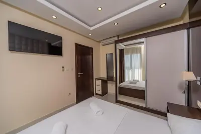 a bedroom with a bed and a tv on the wall at Deluxe Apartments Shine in Becici
