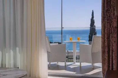 a room with a balcony with a table and chairs at Deluxe Apartments Shine in Becici