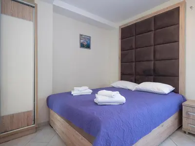 a bedroom with a bed with two towels on it at Palma Rooms & Suites Budva in Budva