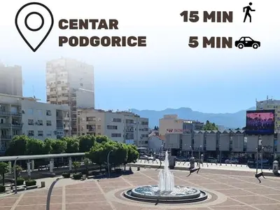 a fountain in the middle of a city with buildings at Old Town Residence in Podgorica