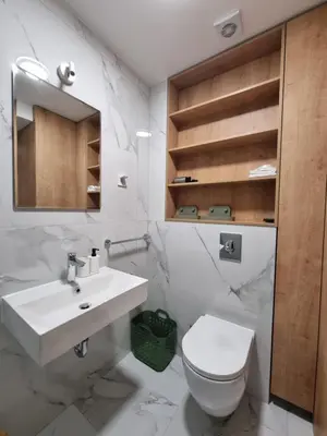 a white bathroom with a sink and a toilet at Old Town Residence in Podgorica