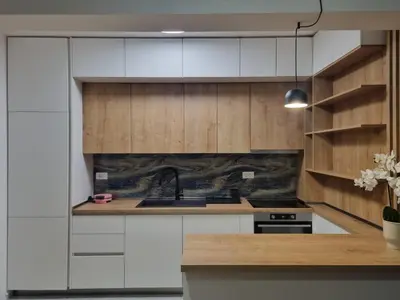 a kitchen with wooden cabinets and a sink at Old Town Residence in Podgorica