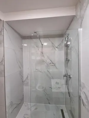 a shower with a glass door in a bathroom at Old Town Residence in Podgorica