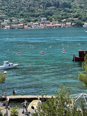 a large body of water with a boat in it at Tetka Apartments in Kotor