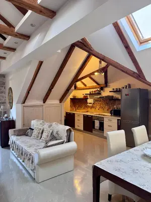 a living room with a couch and a kitchen at Tetka Apartments in Kotor