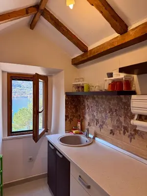 a kitchen with a sink and a window at Tetka Apartments in Kotor