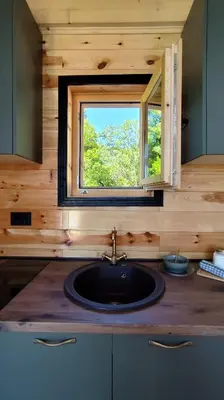 a kitchen with a sink and a window at Above the Lake in Rogani