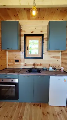 a kitchen with a sink and a stove at Above the Lake in Rogani