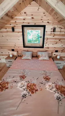 a bedroom with a large bed with flowers on it at Above the Lake in Rogani