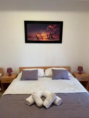 a bedroom with a bed with two towels on it at lifekotor in Kotor