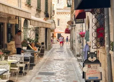 an alley with people walking down a street at lifekotor in Kotor