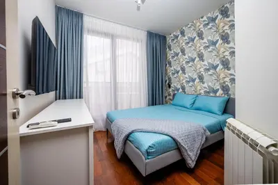 a small bedroom with a bed and a window at Sea View Budva in Budva