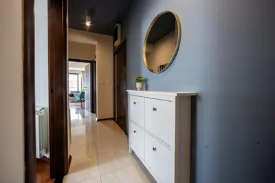 a hallway with a white dresser and a mirror at Sea View Budva in Budva