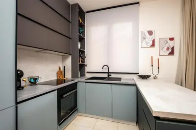 a kitchen with white cabinets and a sink at Sea View Budva in Budva