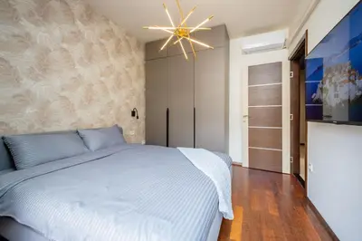 a bedroom with a bed and a ceiling fan at Sea View Budva in Budva