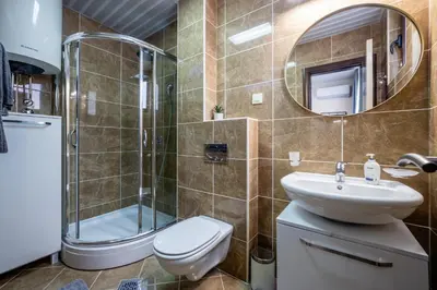 a bathroom with a toilet and a sink and a shower at Sea View Budva in Budva