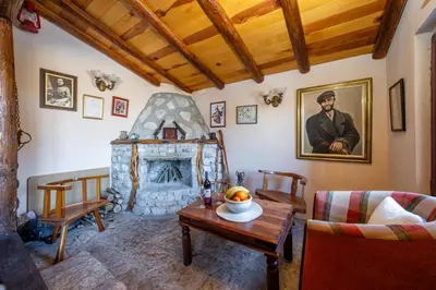 a living room with a fireplace and a table at Montenegro Rustic House I in Bjeloši