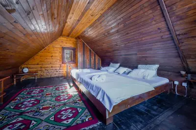a bedroom with a large bed in a wooden cabin at Montenegro Rustic House I in Bjeloši