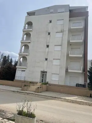 a large white building with stairs and balconies at Guest apartment Mina in Ulcinj