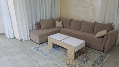 a living room with a couch and a coffee table at Guest apartment Mina in Ulcinj