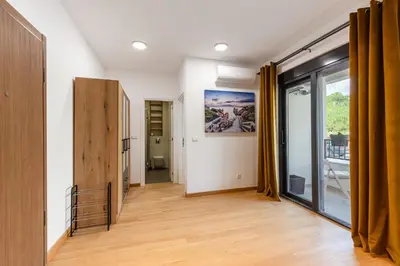 a room with a hallway with a large window at Apartment LEMON in Becici